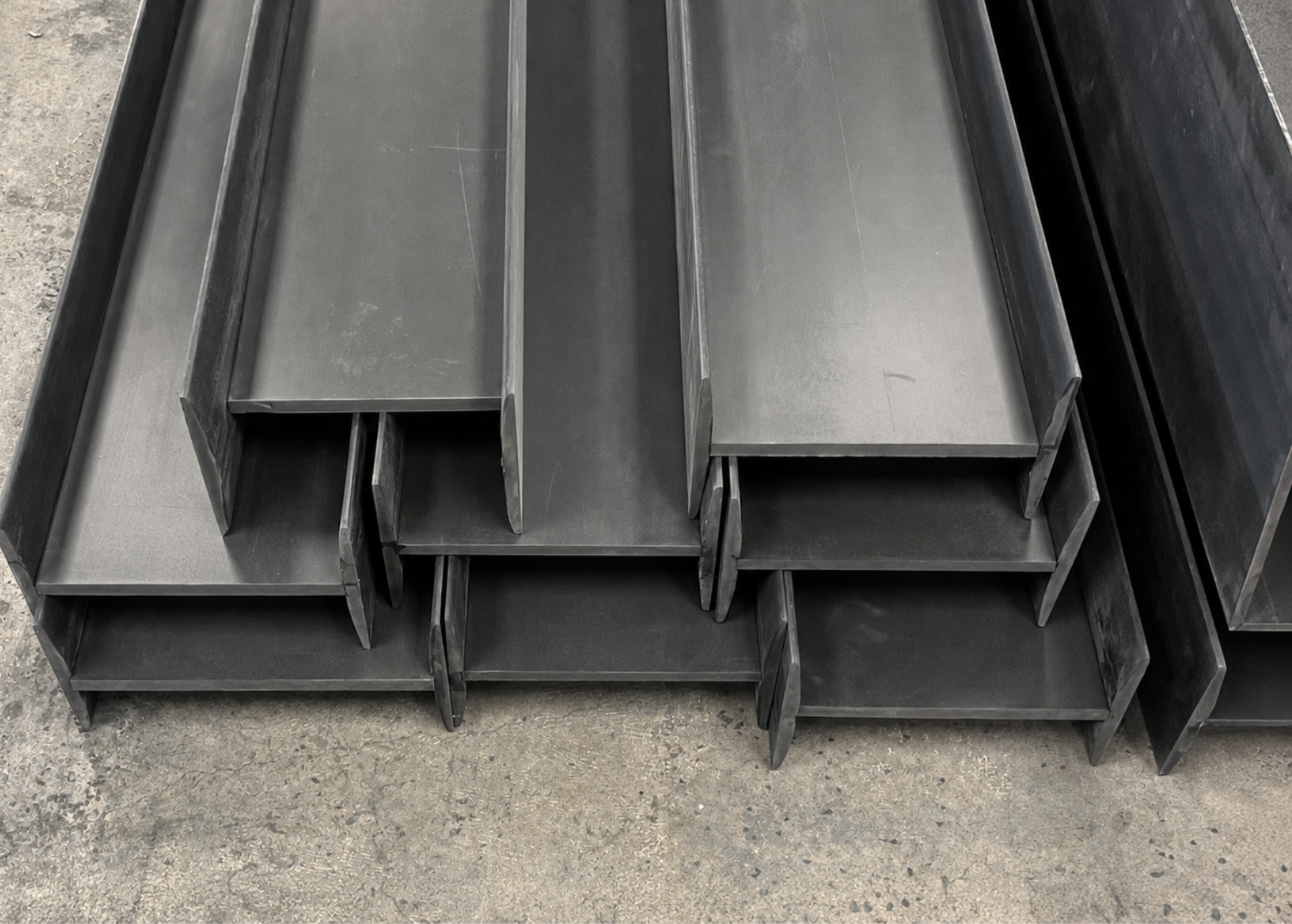 Stacked Featherbeams showing iron gray color through the full thickness of the material
