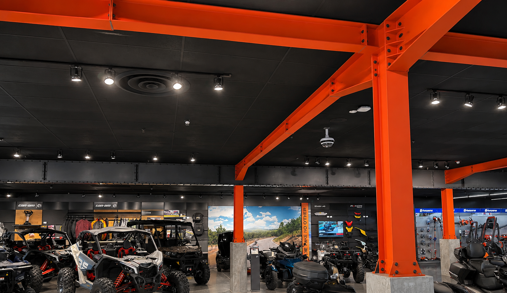 KTM motorsports showroom with bold orange faux steel beams and columns