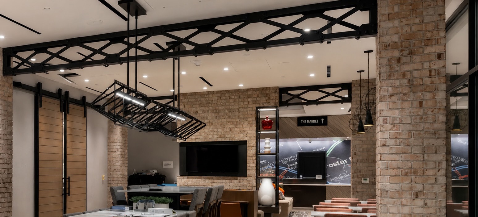 Marriott hotel lobby with black lattice steel trusses and warm brick walls