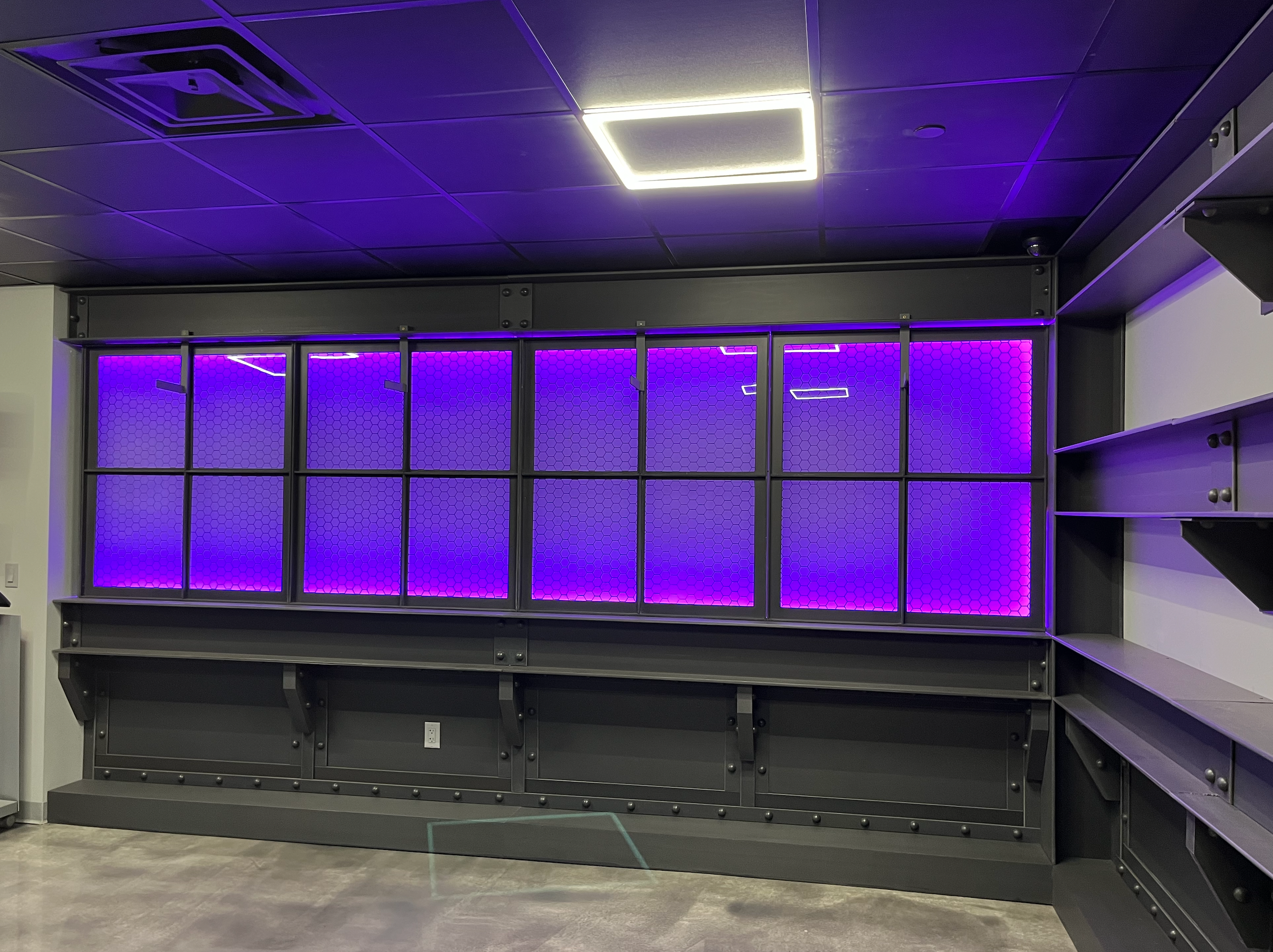 Retail store with faux Featherbeams windows and purple neon lighting