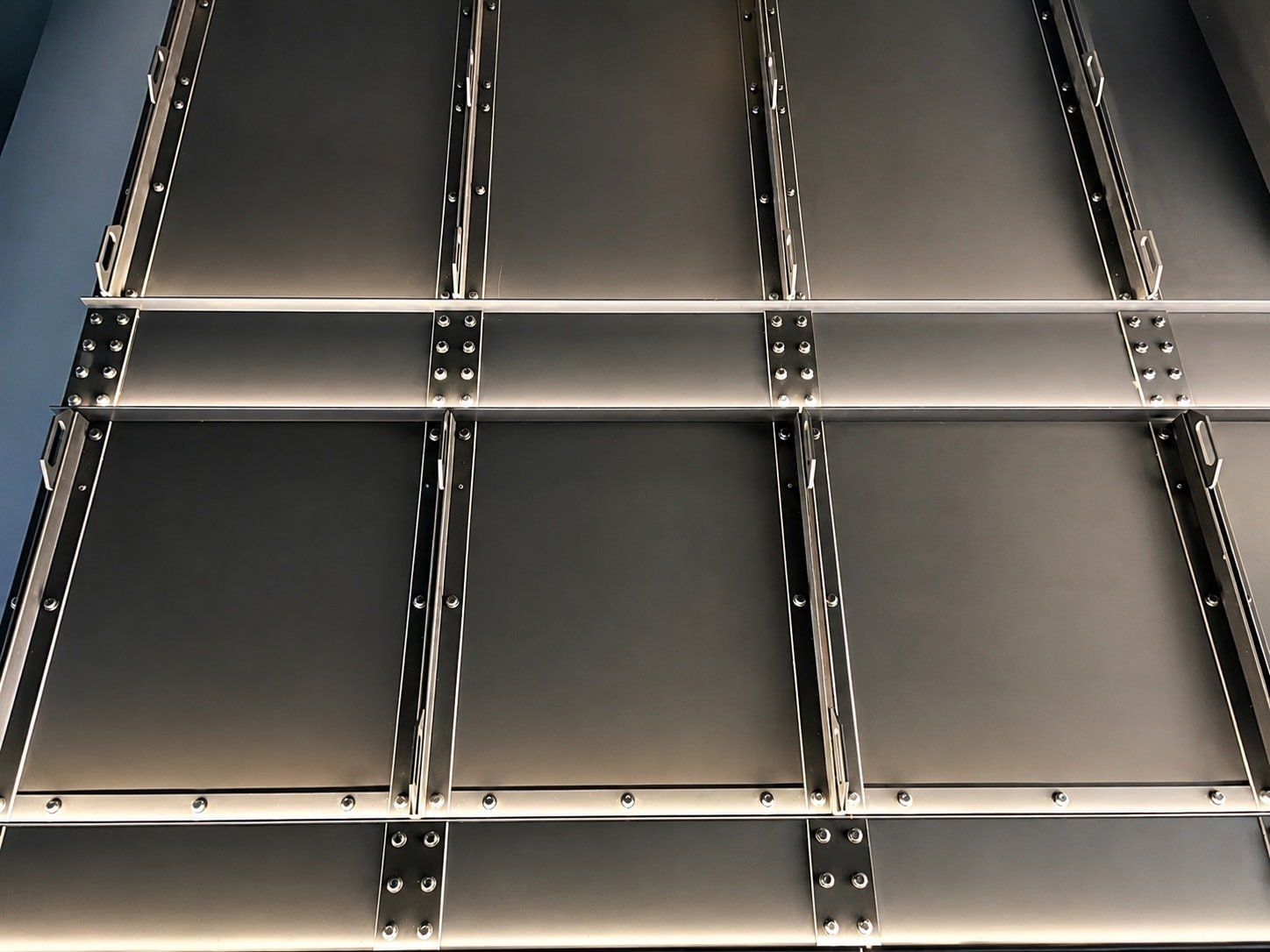 Toyota service area — brushed steel riveted wall panels grid